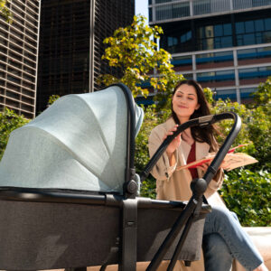 Woman sitting next to stroller in close-up